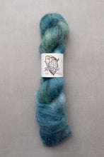 Load image into Gallery viewer, Blue skein of yarn with a label on a gray background
