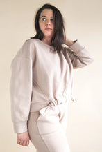 Load image into Gallery viewer, Woman wearing a beige sweatshirt and pants against a plain background