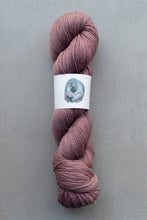 Load image into Gallery viewer, Pink skein of yarn with a label on a gray background