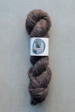 Load image into Gallery viewer, A skein of dark brown wool yarn with a white paper label featuring a blue bear illustration and the brand name 'bear &amp; bear', set against a plain gray background.