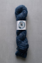 Load image into Gallery viewer, Blue skein of yarn with a label on a gray background