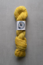 Load image into Gallery viewer, Yellow skein of yarn with a label on a gray background