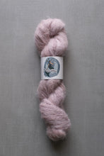 Load image into Gallery viewer, Pink skein of yarn with a label on a gray background