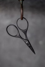 Load image into Gallery viewer, Pair of black-handled scissors hanging on a hook against a dark background