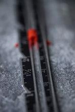 Load image into Gallery viewer, Close-up of a ruler with measurement markings on a textured surface