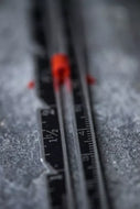 Close-up of a ruler with measurement markings on a textured surface