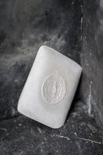 Load image into Gallery viewer, Bar of soap with a logo on a dark stone surface