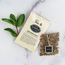 Load image into Gallery viewer, Smith Teas Empower Mint tea package with a clear bag of tea leaves on a marble surface.