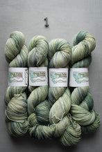 Load image into Gallery viewer, Four skeins of green yarn with 'Great Falls Yarns' labels on a gray background