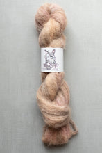 Load image into Gallery viewer, A skein of fluffy hand-dyed wool roving in a soft peach and beige blend, wrapped with a white paper label
