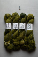 Load image into Gallery viewer, Four skeins of textured olive green yarn with white paper bands