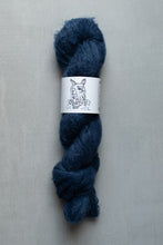 Load image into Gallery viewer, Blue skein of yarn with a label on a gray background