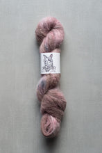 Load image into Gallery viewer, Pink skein of yarn with a label on a gray background