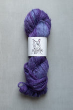 Load image into Gallery viewer, Purple skein of yarn with a label on a gray background