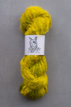 Load image into Gallery viewer, Yellow skein of yarn with a label on a gray background