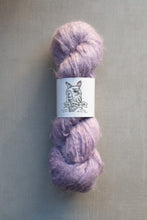 Load image into Gallery viewer, Purple skein of yarn with a label on a gray background