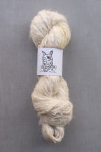 Load image into Gallery viewer, Ball of cream-colored yarn with a label on a gray background