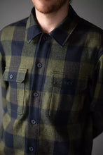 Load image into Gallery viewer, Person wearing a green and navy plaid shirt with a neutral background