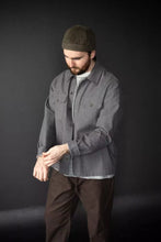 Load image into Gallery viewer, Man wearing a gray jacket and brown pants against a black background