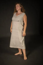 Load image into Gallery viewer, Woman wearing a sleeveless dress against a black background