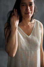 Load image into Gallery viewer, Woman wearing a sleeveless checkered dress against a gray background
