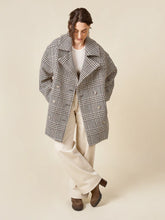 Load image into Gallery viewer, Person wearing a plaid coat on a beige background