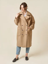Load image into Gallery viewer, Woman wearing a beige coat on a plain background