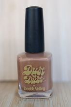 Load image into Gallery viewer, Nail polish bottle with &#39;Dust to Dust by Death Valley&#39; on a wooden surface.