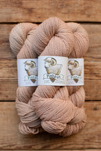 Load image into Gallery viewer, Two skeins of pink yarn with 'Pishkaun' labels on a wooden background