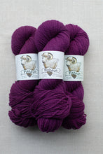 Load image into Gallery viewer, Three skeins of deep purple yarn with white paper labels featuring a ram illustration and the brand name 'Pishkun', arranged on a light gray textured background.