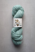 Load image into Gallery viewer, A skein of mint green yarn with a white paper label