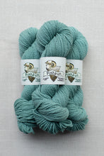 Load image into Gallery viewer, Three skeins of teal yarn with white paper bands labeled 'Pishkun' and a ram illustration, arranged on a light gray textured background.