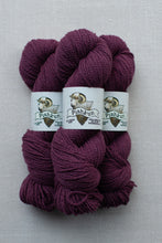 Load image into Gallery viewer, Three skeins of Pishkun brand yarn in a deep plum purple color, arranged vertically on a light gray textured background.
