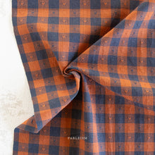 Load image into Gallery viewer, Plaid fabric with blue and orange pattern on a textured surface, featuring the brand 'Fableism'.