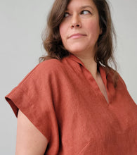 Load image into Gallery viewer, Woman wearing a rust-colored shirt against a plain background