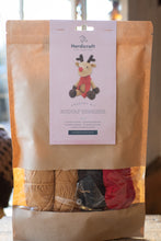 Load image into Gallery viewer, Crochet kit with yarn and a patterned label on a wooden surface