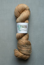 Load image into Gallery viewer, Yarn skein with a label on a gray background