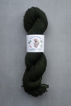 Load image into Gallery viewer, Dark green skein of yarn with a label on a gray background