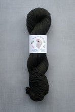 Load image into Gallery viewer, Dark skein of yarn with a label on a gray background