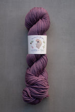 Load image into Gallery viewer, Purple skein of yarn with a label on a gray background