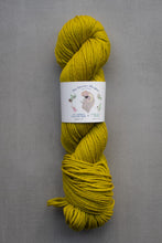 Load image into Gallery viewer, Yellow skein of yarn with a label on a gray background