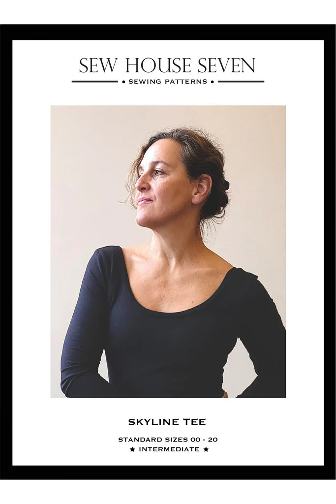 Advertisement for Sew House Seven Skyline Tee sewing pattern with a woman wearing a black shirt.