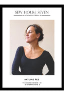 Advertisement for Sew House Seven Skyline Tee sewing pattern with a woman wearing a black shirt.