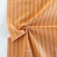 Striped fabric with a visible brand name on a light background