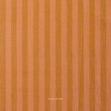 Load image into Gallery viewer, Textured fabric with vertical stripes in shades of brown and orange, featuring the brand 'Fableism'.