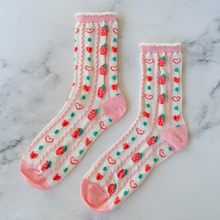 Load image into Gallery viewer, Pair of socks with heart and strawberry pattern on a marble surface
