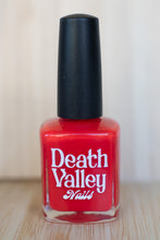 Load image into Gallery viewer, Red nail polish bottle with &#39;Death Valley Nails&#39; label on a neutral background