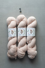 Load image into Gallery viewer, Three skeins of pink yarn with labels on a gray background