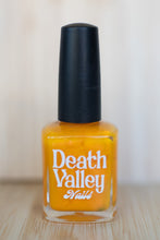 Load image into Gallery viewer, Bottle of &#39;Death Valley Nails&#39; nail polish with a black cap on a light wooden surface.
