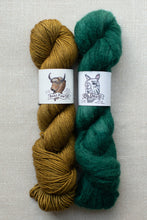 Load image into Gallery viewer, Two skeins of yarn side by side on a light beige textured background. The left skein is a warm mustard yellow with a white paper label featuring a bull illustration and the text 'Beast Cow'.